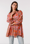 a vibrant orange and pink cotton block print bohemian tunic top