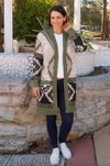 a thick winter wool blend knitted coat with aztec design in neutral tones of khaki , black and beige