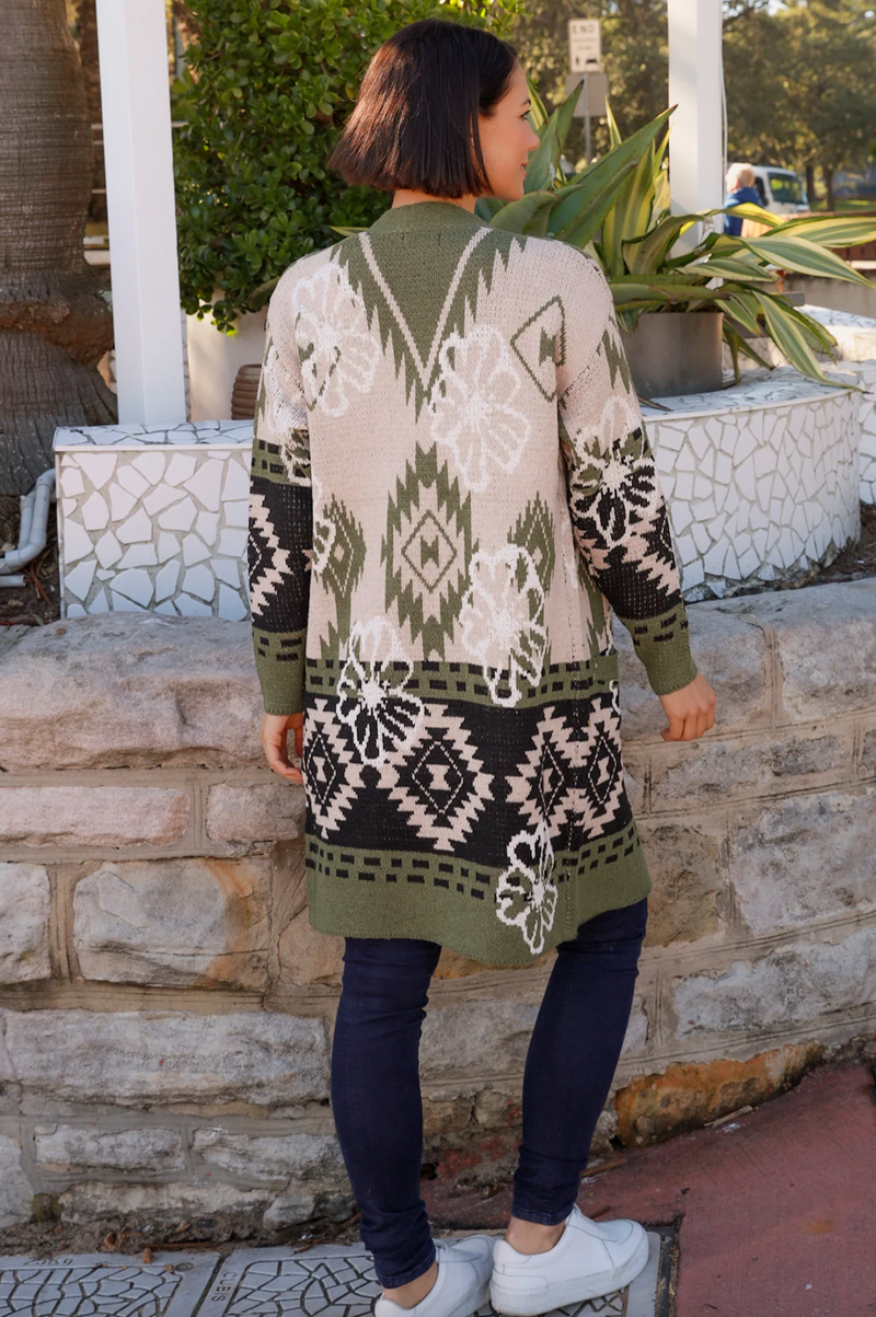 a thick winter wool blend knitted coat with aztec design in neutral tones of khaki , black and beige