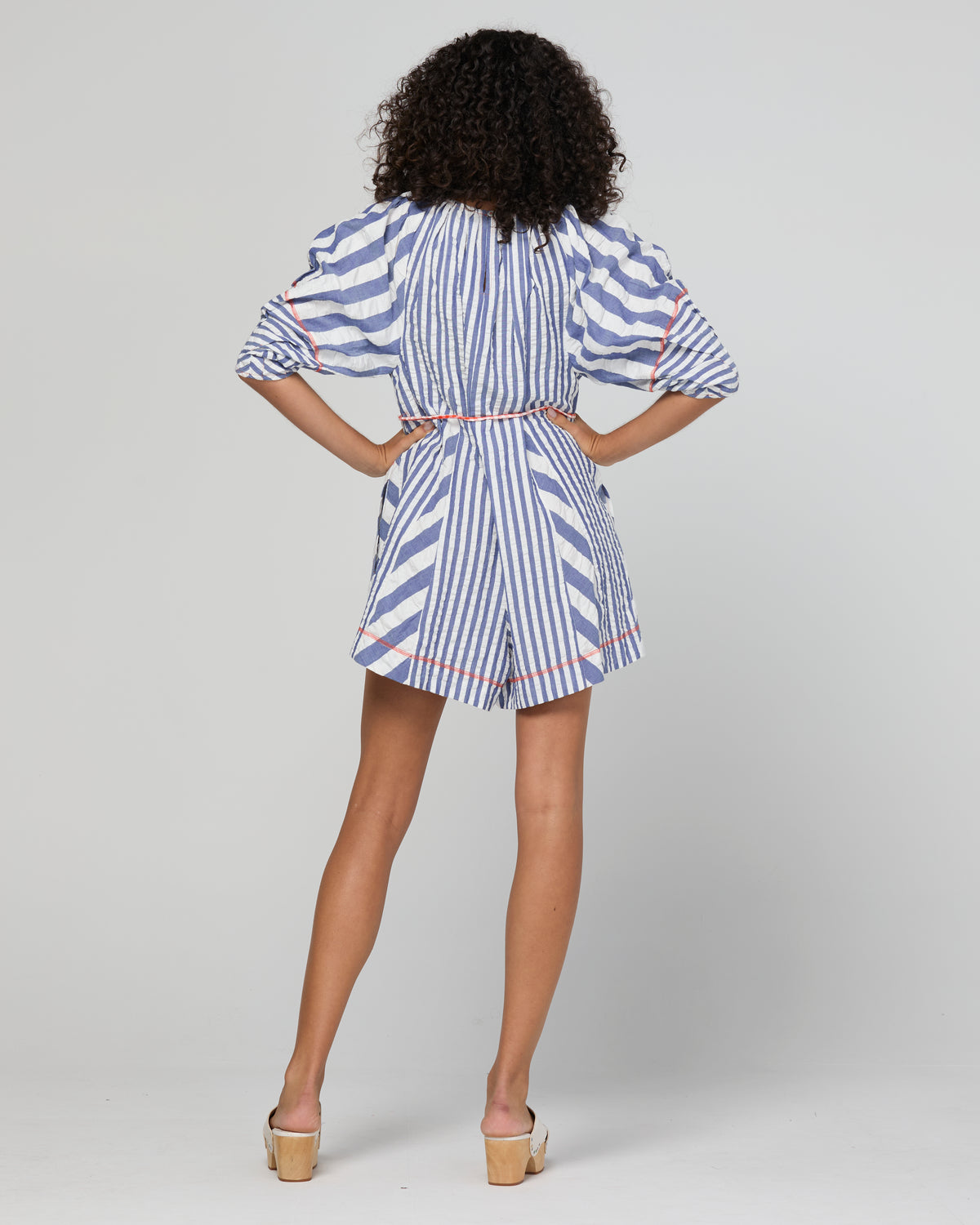 Lucia playsuit by Boom Shankar is a blue and white striped short suit made from cotton seersucker