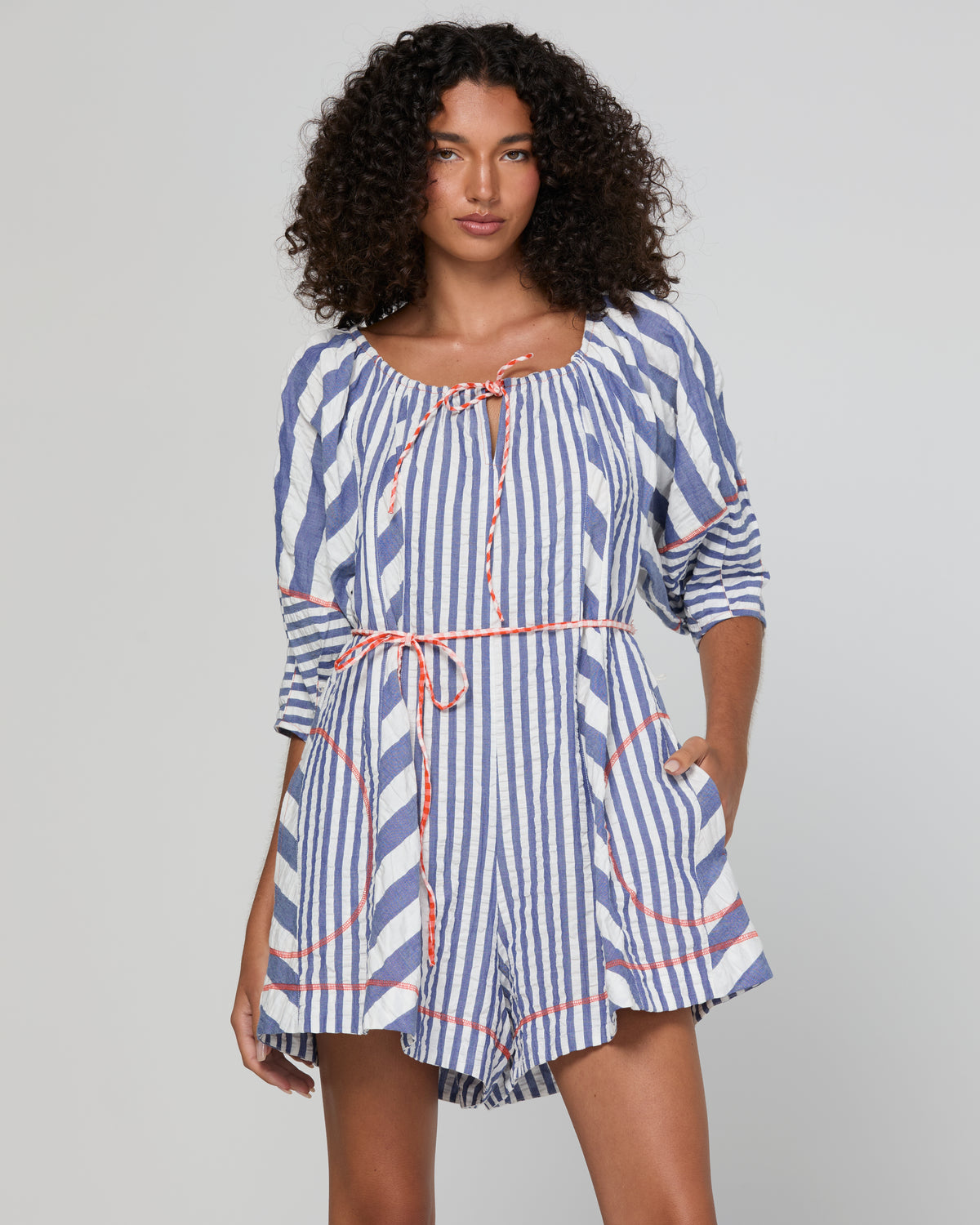Lucia playsuit by Boom Shankar is a blue and white striped short suit made from cotton seersucker