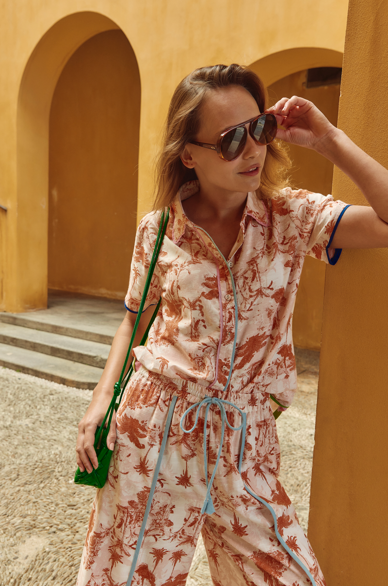 The cuba shirt from boom shankar is a button up short sleeve shirt with rust palm print