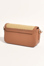 the hattie weave bag by adorne is a crossbody bag converted to a shoulder bag