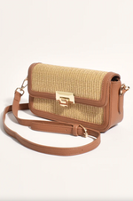 the hattie weave bag by adorne is a crossbody bag converted to a shoulder bag