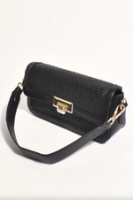 the hattie weave bag by adorne is a crossbody bag converted to a shoulder bag