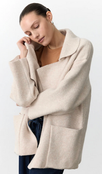 Woman wearing a beige oversized coatigan by little lies