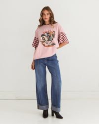 saddle up beauty tee by paper heart is a pink cotton t-shirt with contrats check sleeves and cowgirl image on the front