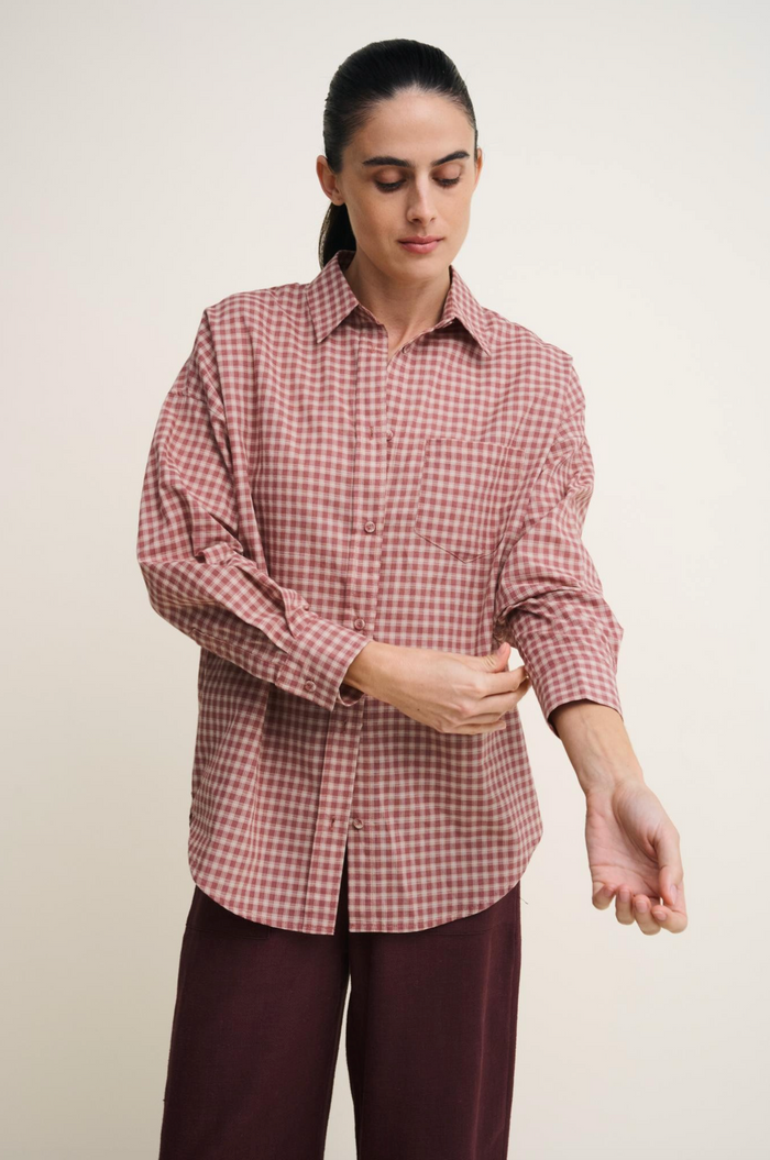 Ruby Check shirt is a long-sleeve button-up shirt with a pink and burgundy gingham pattern by Little Lies paired with burgundy Osaka pants