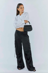 amalie crossbody bag by peta and jain is a vegan leather bag with a top handle in black