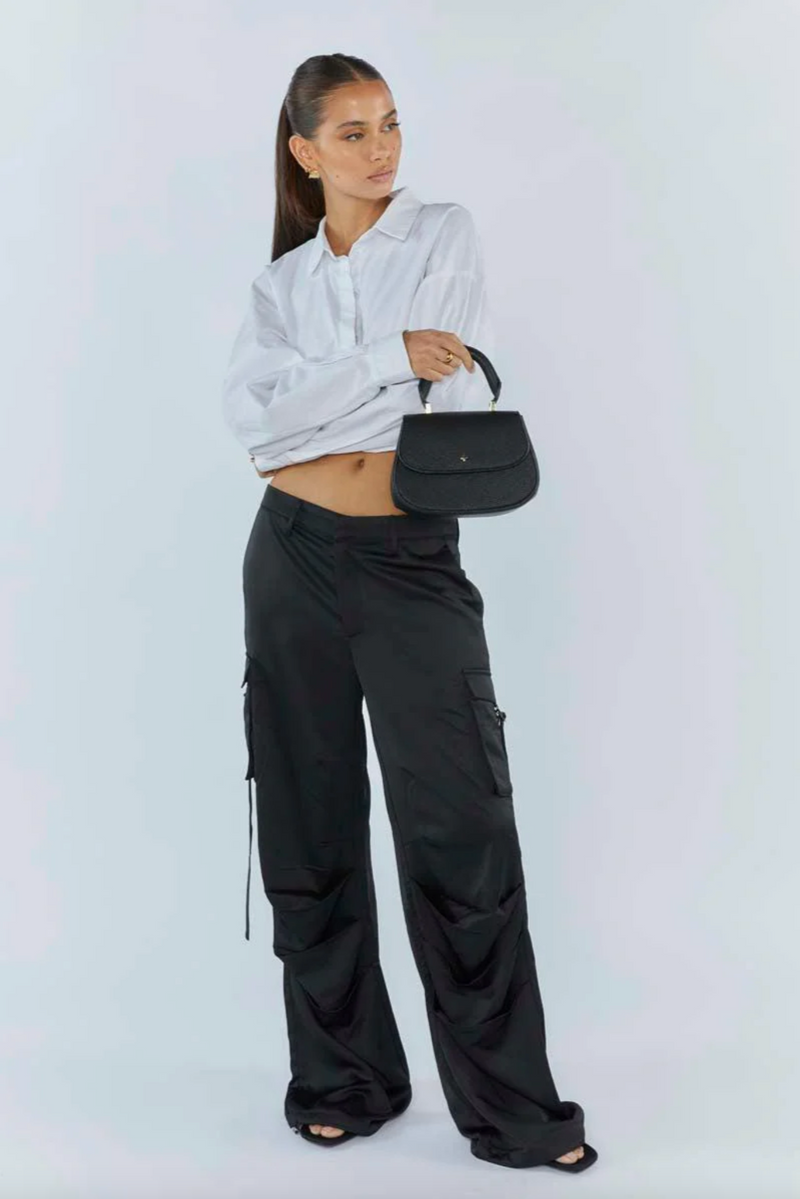 amalie crossbody bag by peta and jain is a vegan leather bag with a top handle in black