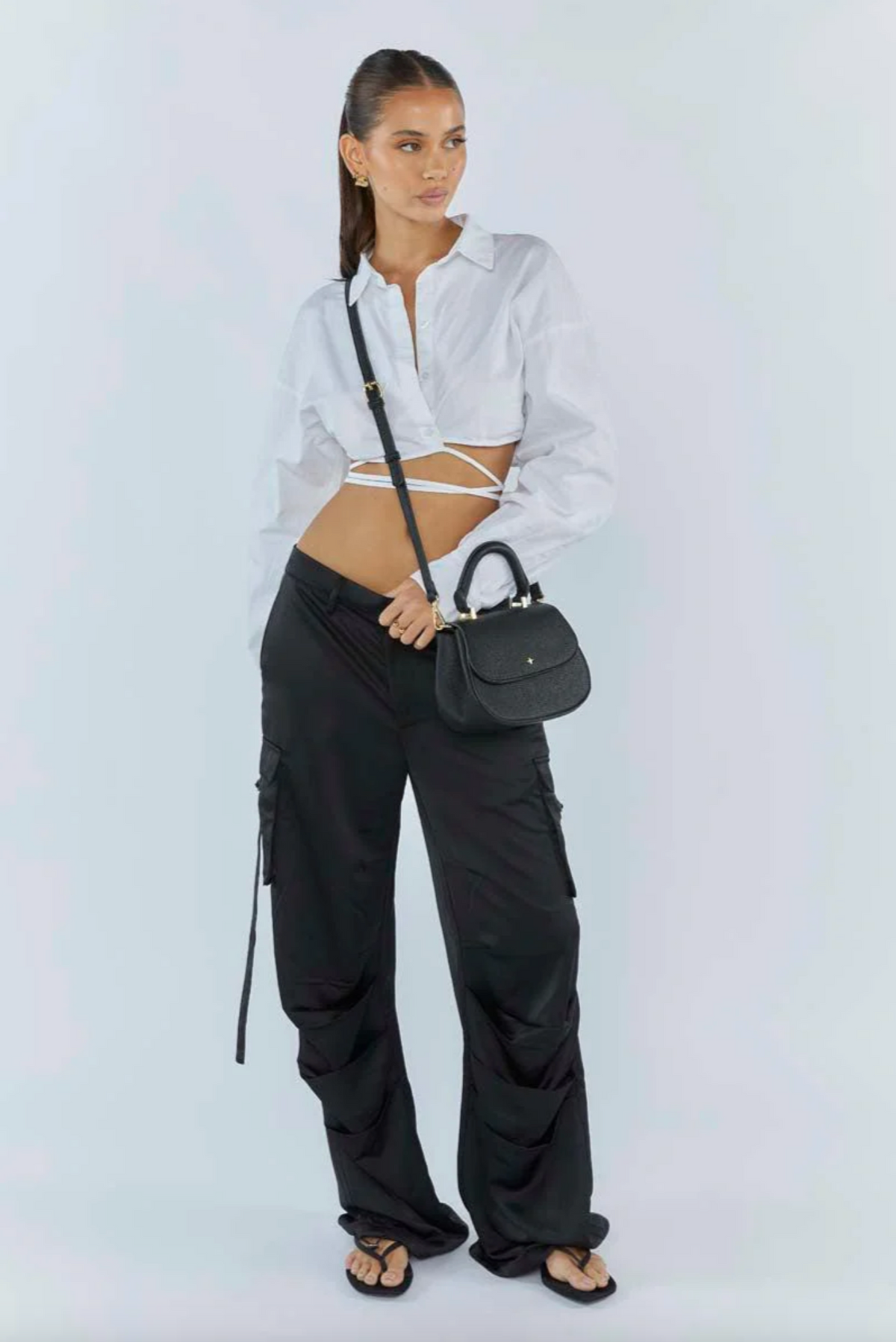 amalie crossbody bag by peta and jain is a vegan leather bag with a top handle in black