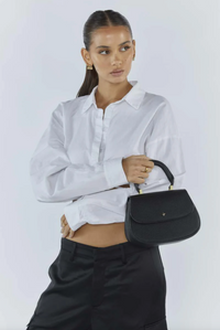 amalie crossbody bag by peta and jain is a vegan leather bag with a top handle in black