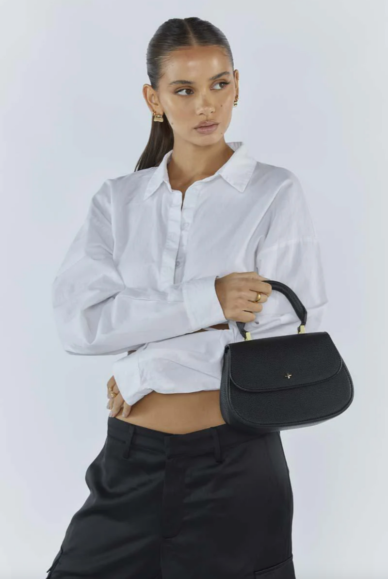 amalie crossbody bag by peta and jain is a vegan leather bag with a top handle in black