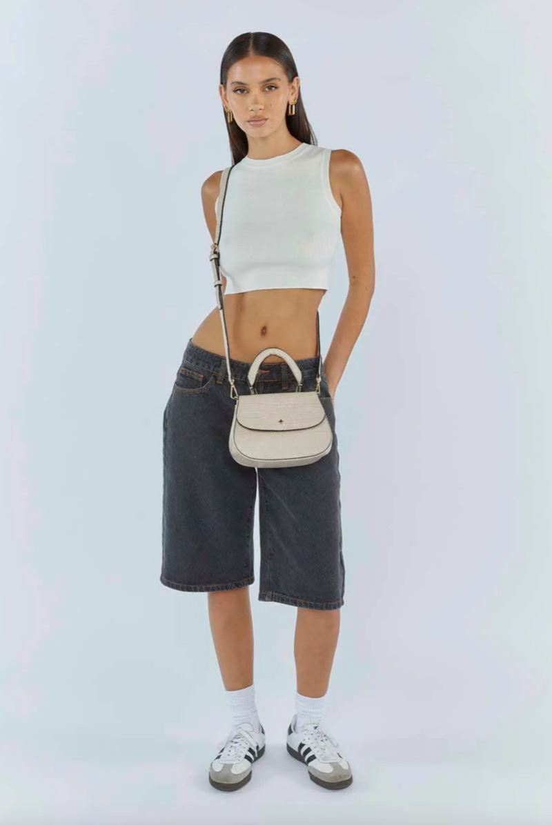 amalie crossbody bag by peta and jain is a vegan leather bag with a top handle in nude croc