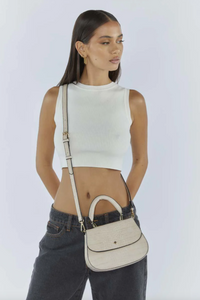 amalie crossbody bag by peta and jain is a vegan leather bag with a top handle in nude croc