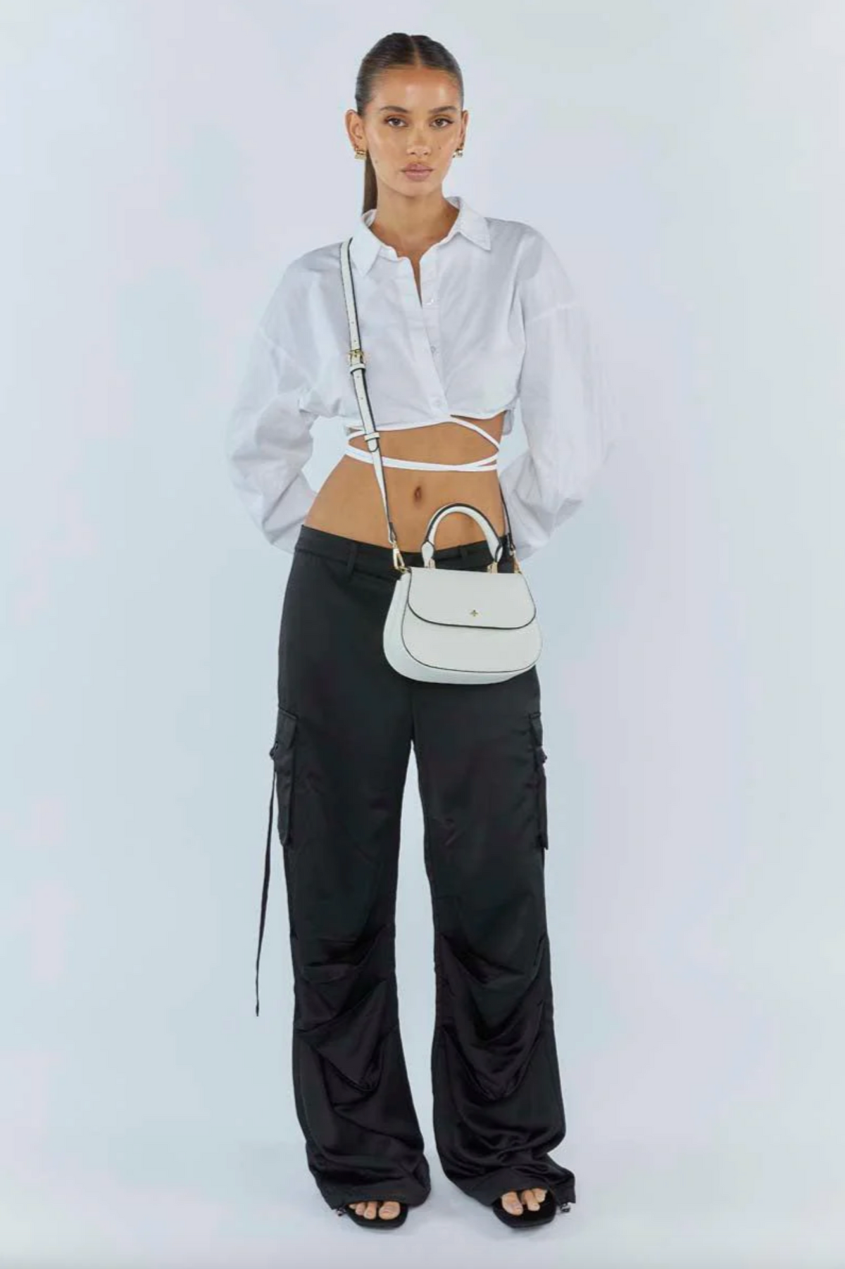 amalie crossbody bag by peta and jain is a vegan leather bag with a top handle in white pebble