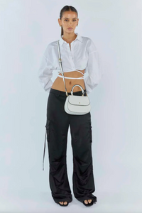 amalie crossbody bag by peta and jain is a vegan leather bag with a top handle in white pebble