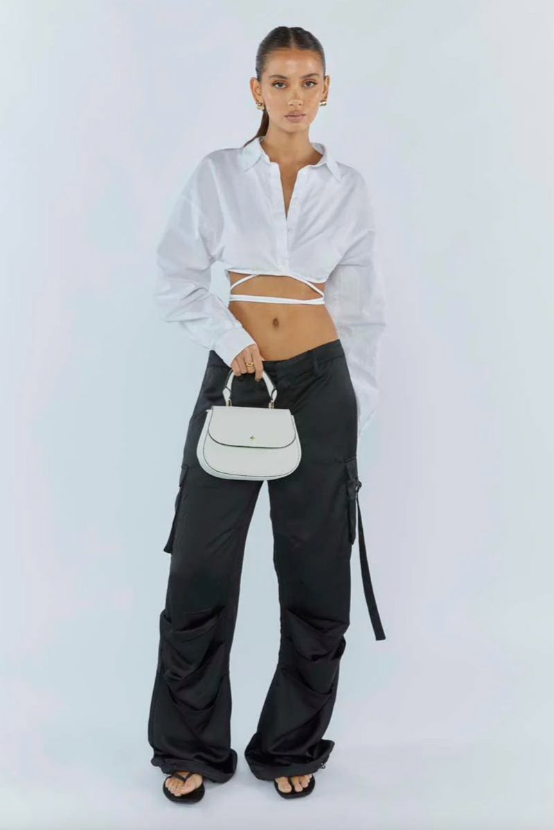 amalie crossbody bag by peta and jain is a vegan leather bag with a top handle in white pebble