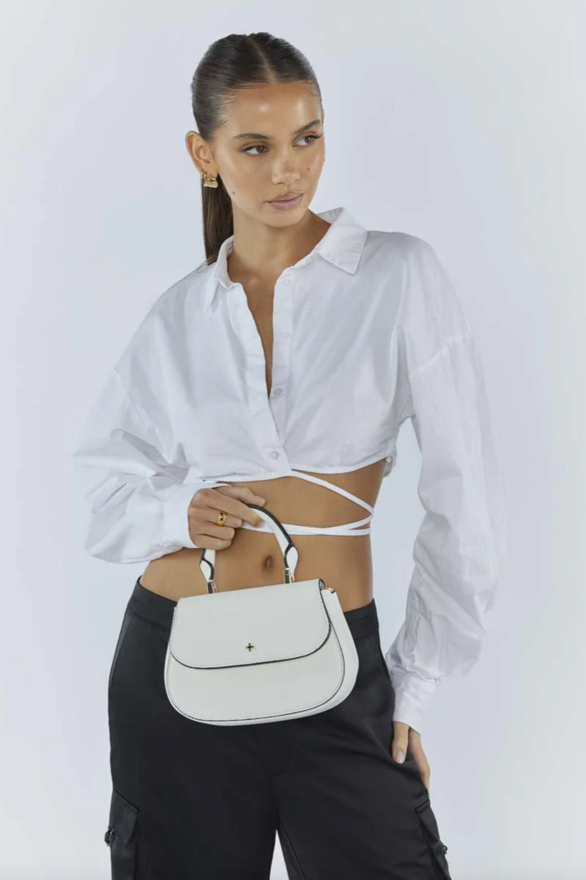 amalie crossbody bag by peta and jain is a vegan leather bag with a top handle in white pebble