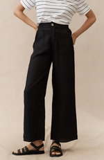 The Jude Linen pants by Little Lies are a wide leg black linen pants with zip and button closure and side pockets 