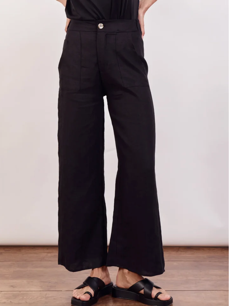 The Jude Linen pants by Little Lies are a wide leg black linen pants with zip and button closure and side pockets 
