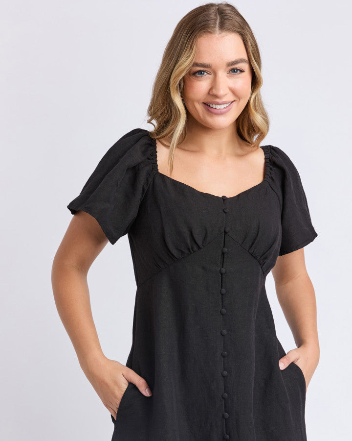 a black linen dress with pockets and sweetheart neckline