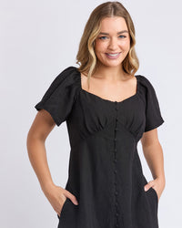 a black linen dress with pockets and sweetheart neckline