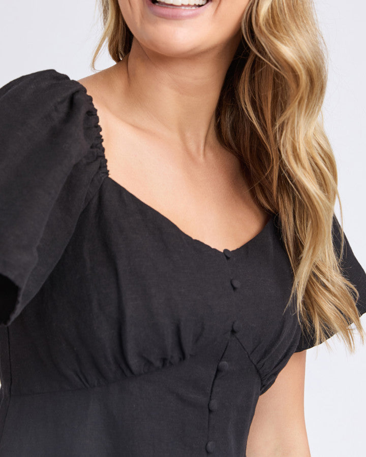 the juni dress by foxwood is a black linen blend midi length dress