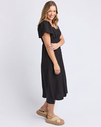a black linen dress with pockets and sweetheart neckline by foxwood