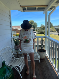 Mermaid vino club tee by frankie is a white cotton t-shirt with a mermaid riding a tiger sipping wine