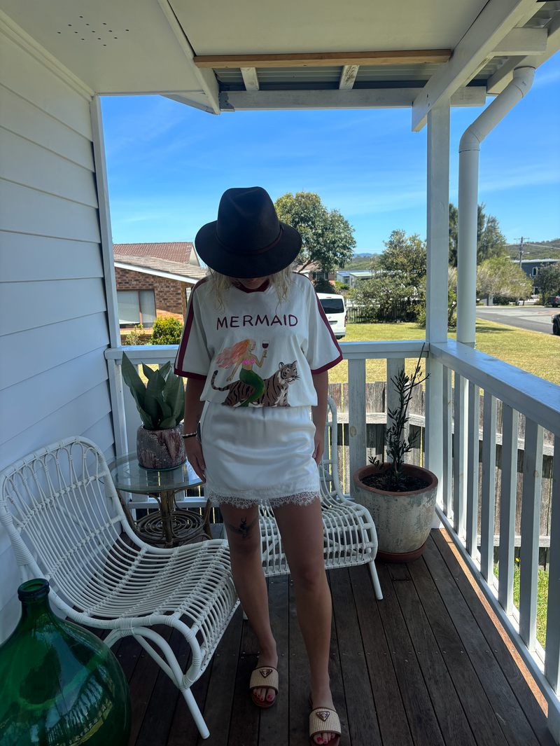 Mermaid vino club tee by frankie is a white cotton t-shirt with a mermaid riding a tiger sipping wine