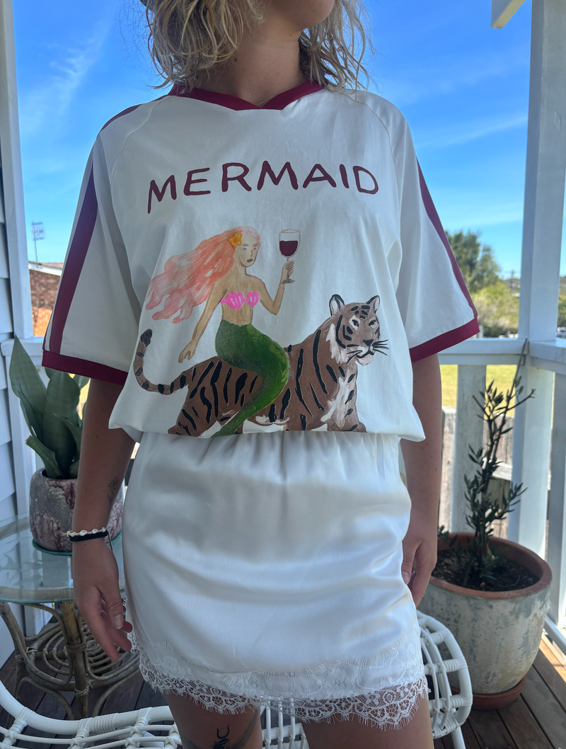 Mermaid vino club tee by frankie is a white cotton t-shirt with a mermaid riding a tiger sipping wine