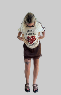 most wanted tee by frankie is a cotton t-shirt with a flaming heart and gun image