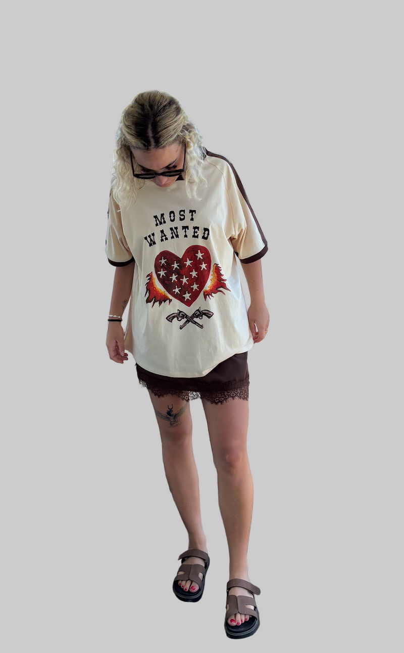 most wanted tee by frankie is a cotton t-shirt with a flaming heart and gun image