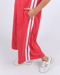 the recovery dress by foxwood is a red cotton v-neck a-line dress with pockets and midi length